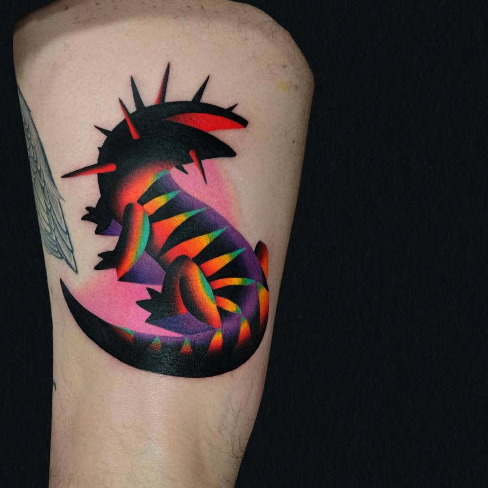 Colorful salamander tattoo placed on the thigh.