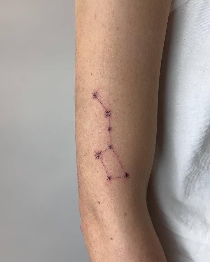 Minimalistic style Big Dipper tattoo located on the upper arm.
