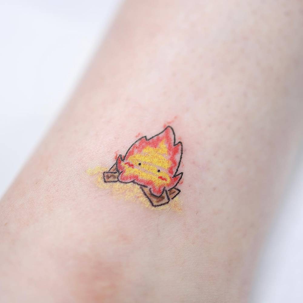Calcifer bonfire tattoo located on the ankle, cartoon style.