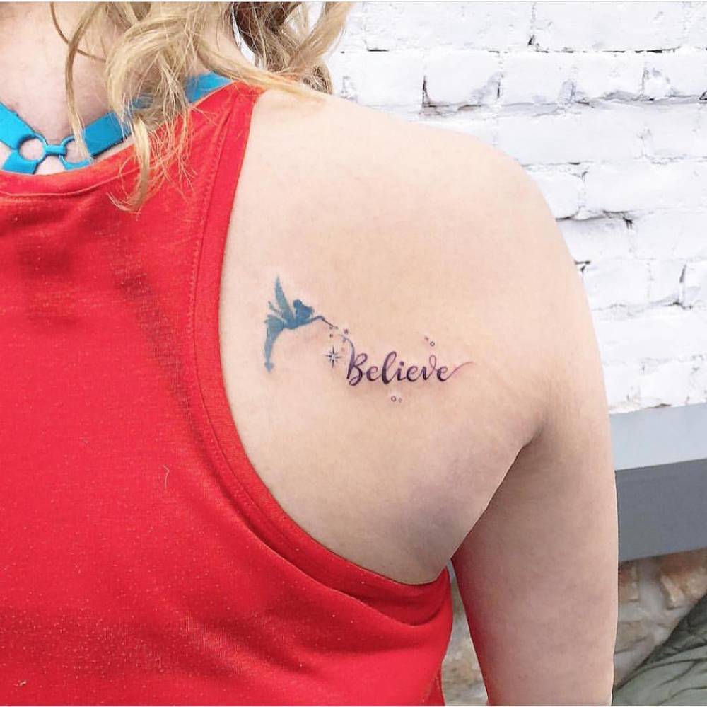 Watercolor Tinker Bell and "believe" tattoo on the shoulder blade.