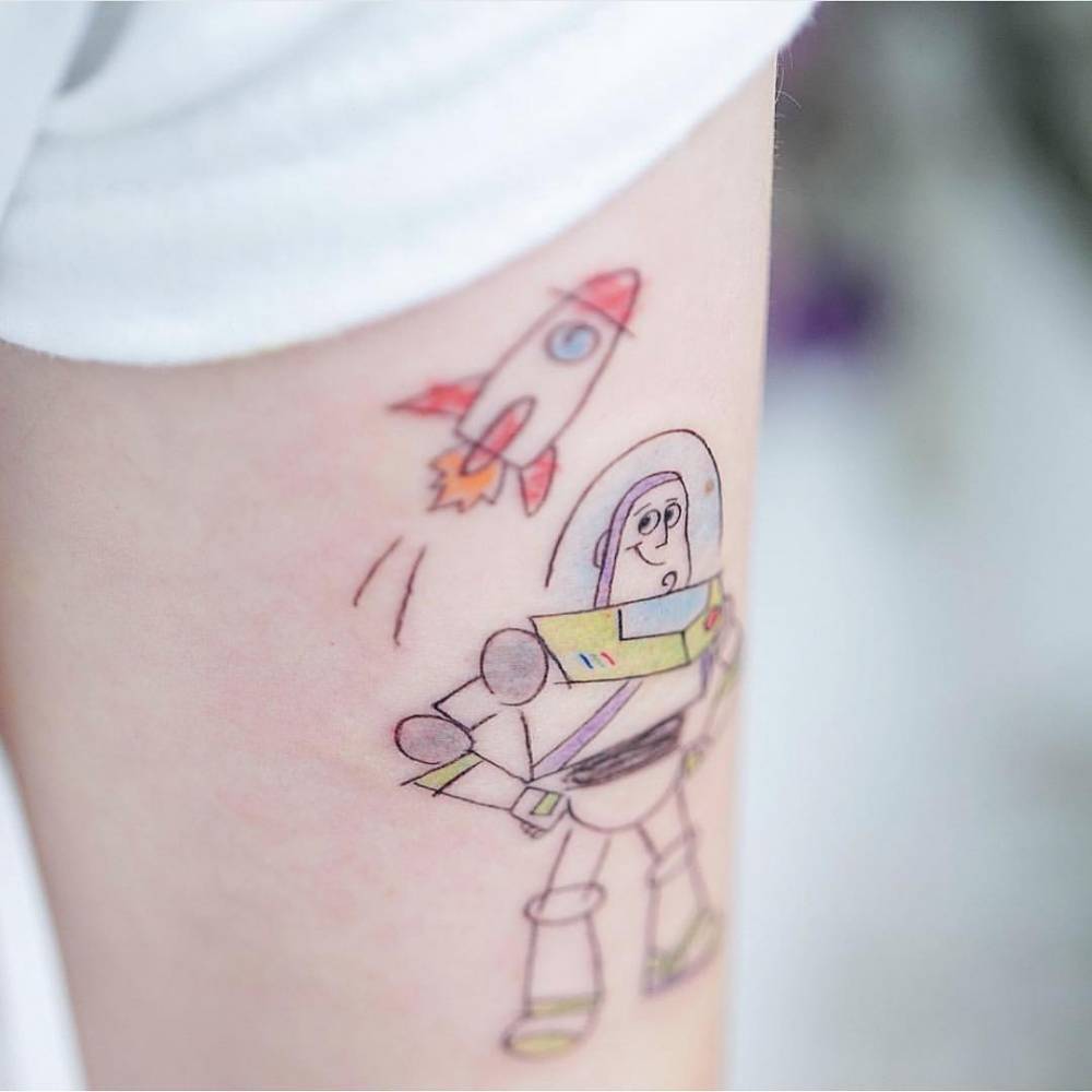 Buzz Lightyear tattoo on the tricep.