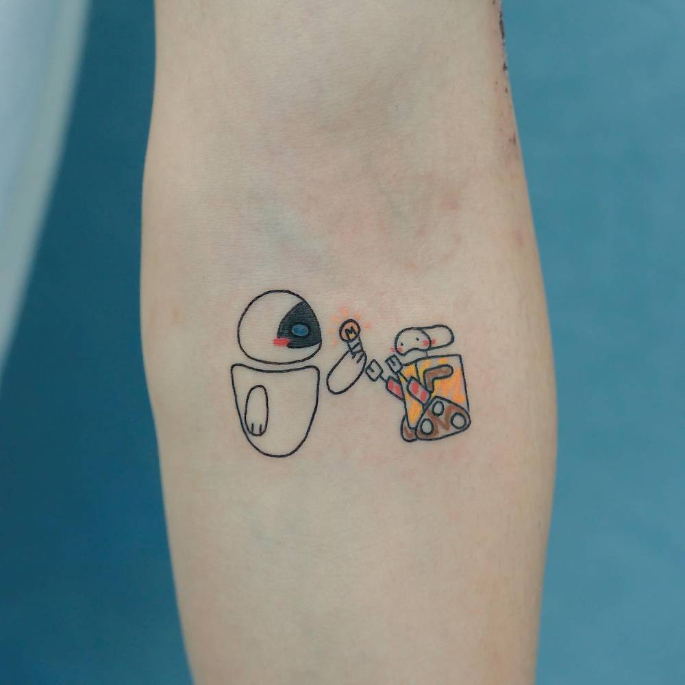 WALL-E tattoo in cartoon style located on the inner forearm.