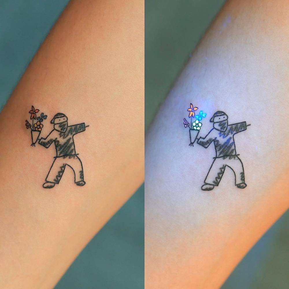 Flower Thrower tattoo located on the inner forearm.