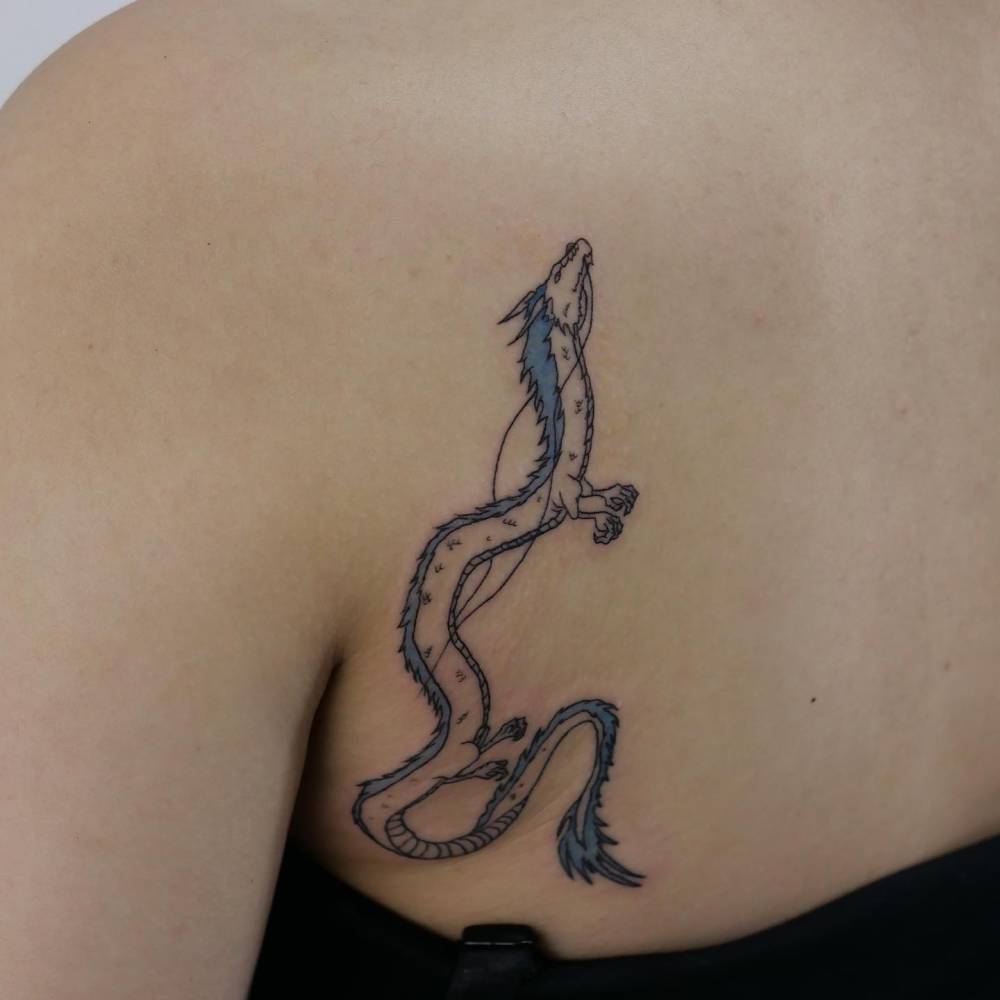 Cartoon style Haku tattoo located on the shoulder blade.