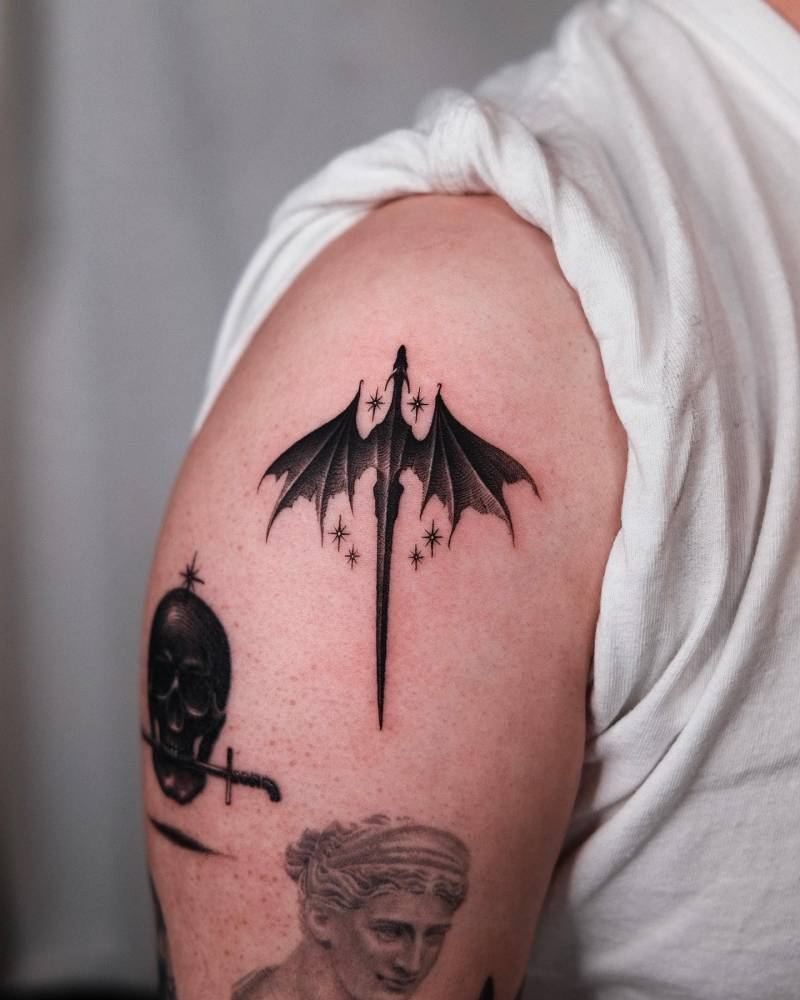 Dragon tattoo located on the shoulder, illustrative style.