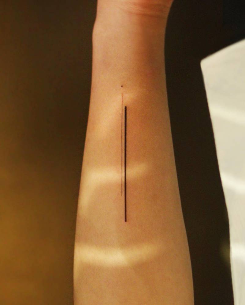 Minimalistic lines tattooed on the wrist.