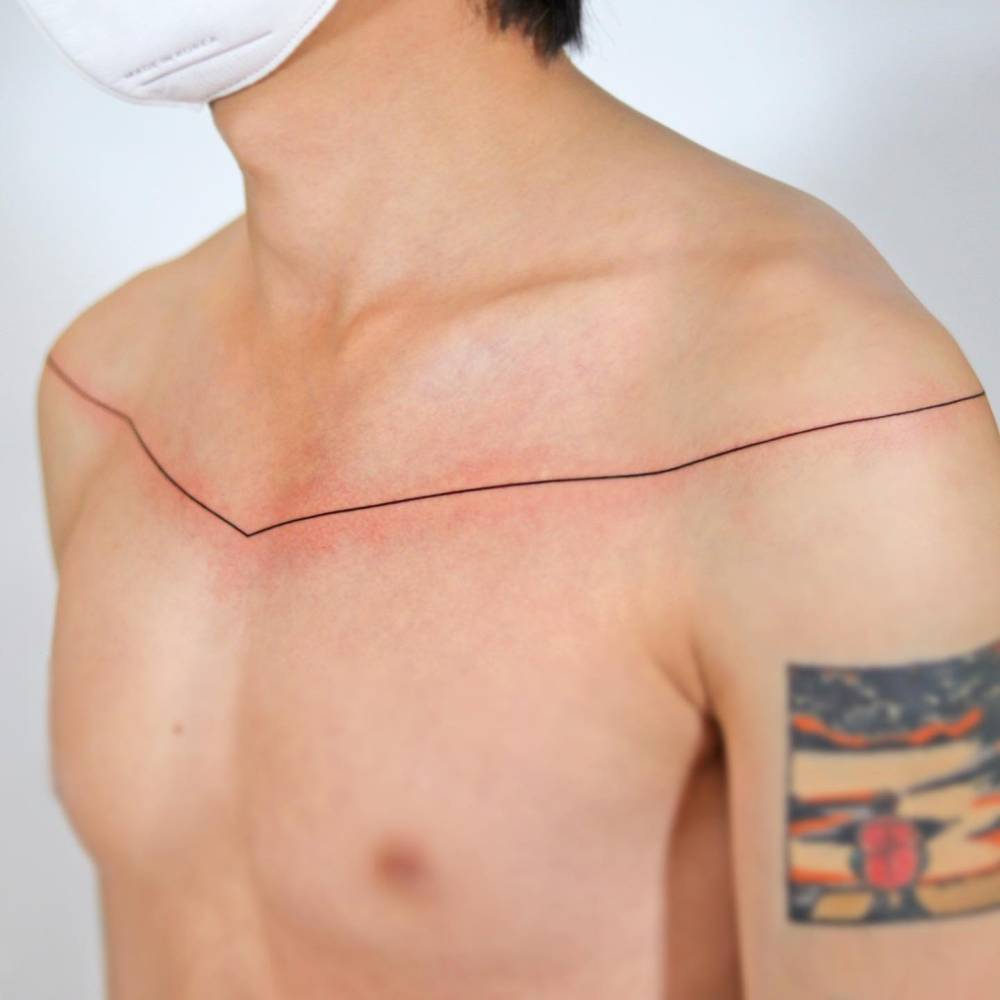 Minimalistic style line tattoo located on the chest.