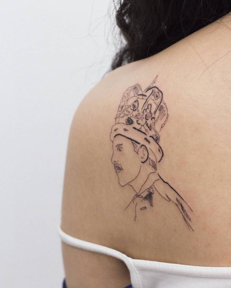 Sketch work style Freddie Mercury portrait tattoo done on the shoulder blade.