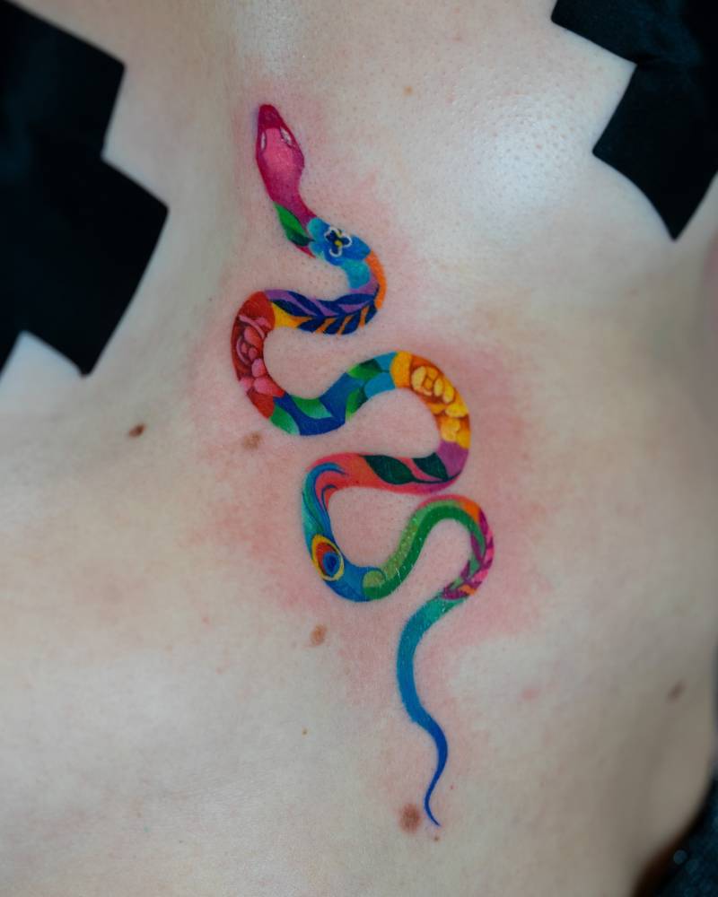 Snake tattoo in illustrative style located on the sternum.