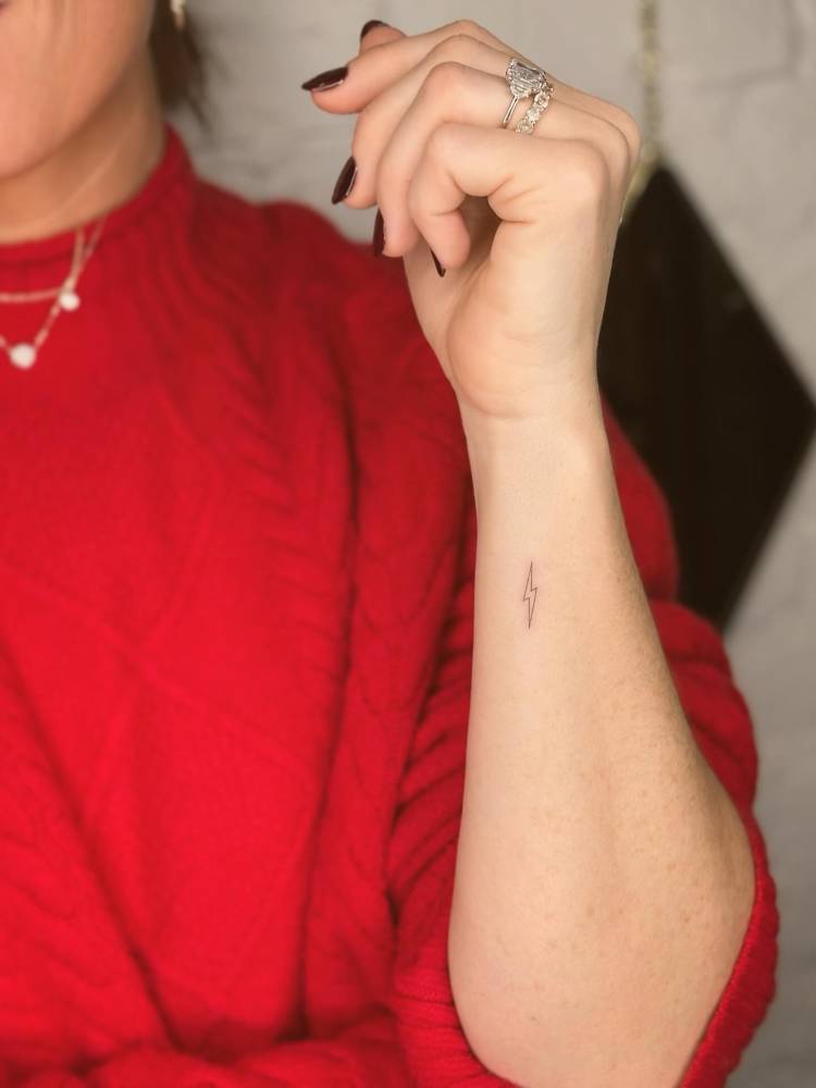 Minimalistic little lightning bolt tattoo done on the wrist.