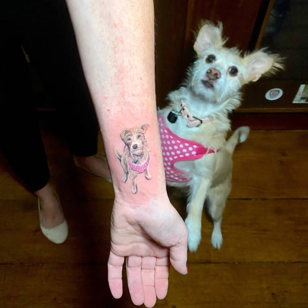 Jack Russell tattoo in micro-realistic style located on the wrist.