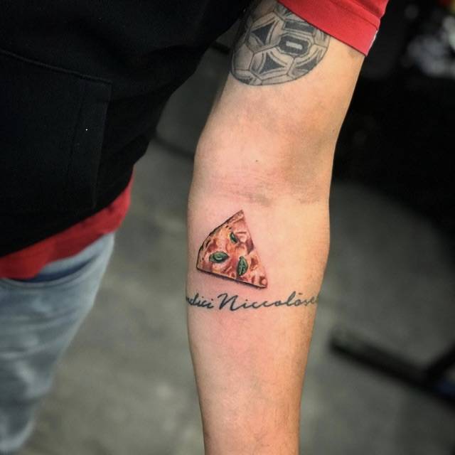 Pizza margherita tattooed on the inner forearm, micro-realistic style.
