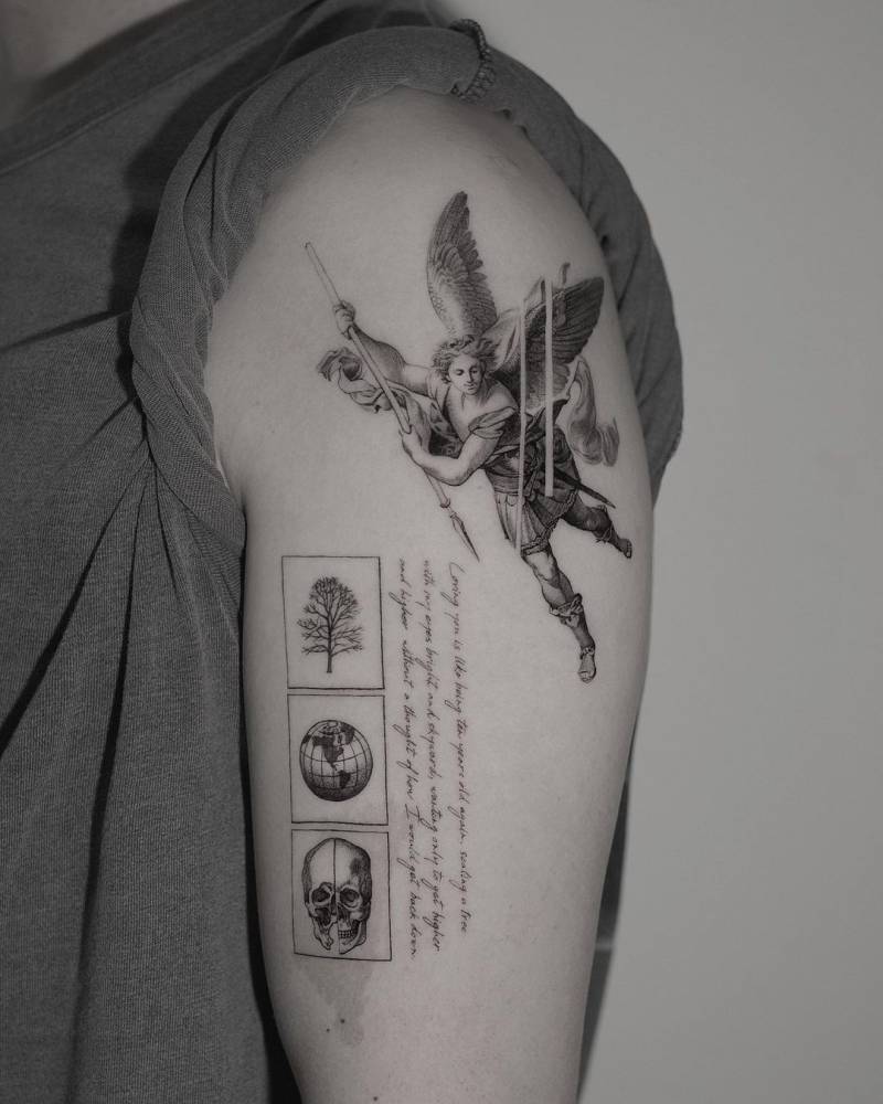 Micro-realistic Archangel Michael tattoo on the upper arm.
