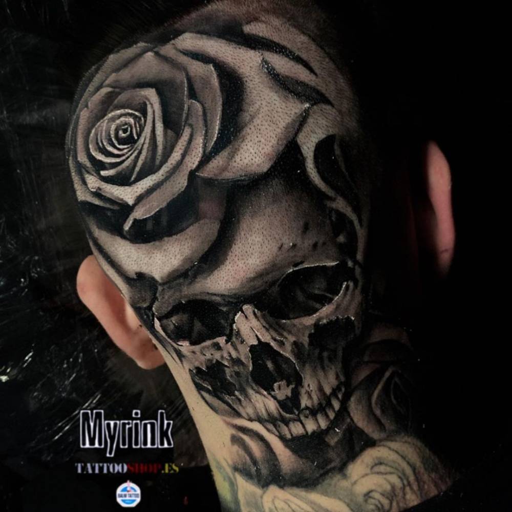Black and grey rose and skull tattoo on the head.