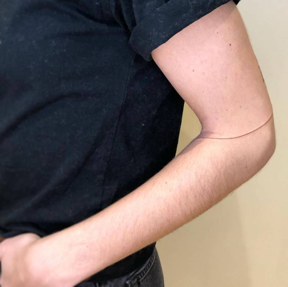 Line tattoo on the elbow.