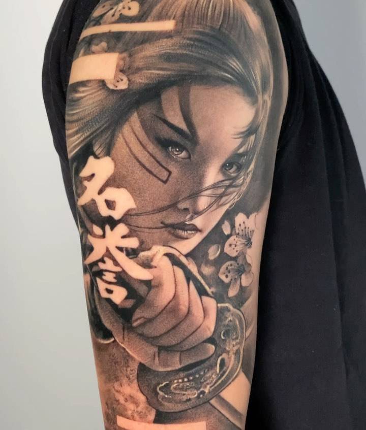 Onna-Bugeisha half sleeve tattoo done in black and grey style.