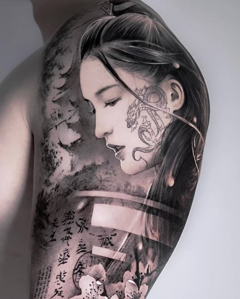 Geisha portrait tattoo located on the upper arm.
