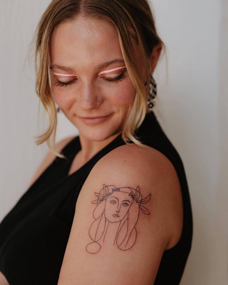 Picasso's Visage artwork tattoo located on the upper arm.