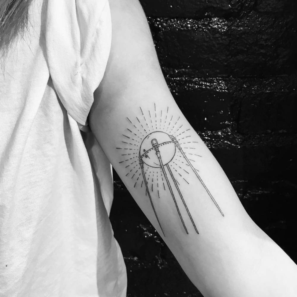 FIne line style Sputnik tattoo located on the inner arm.
