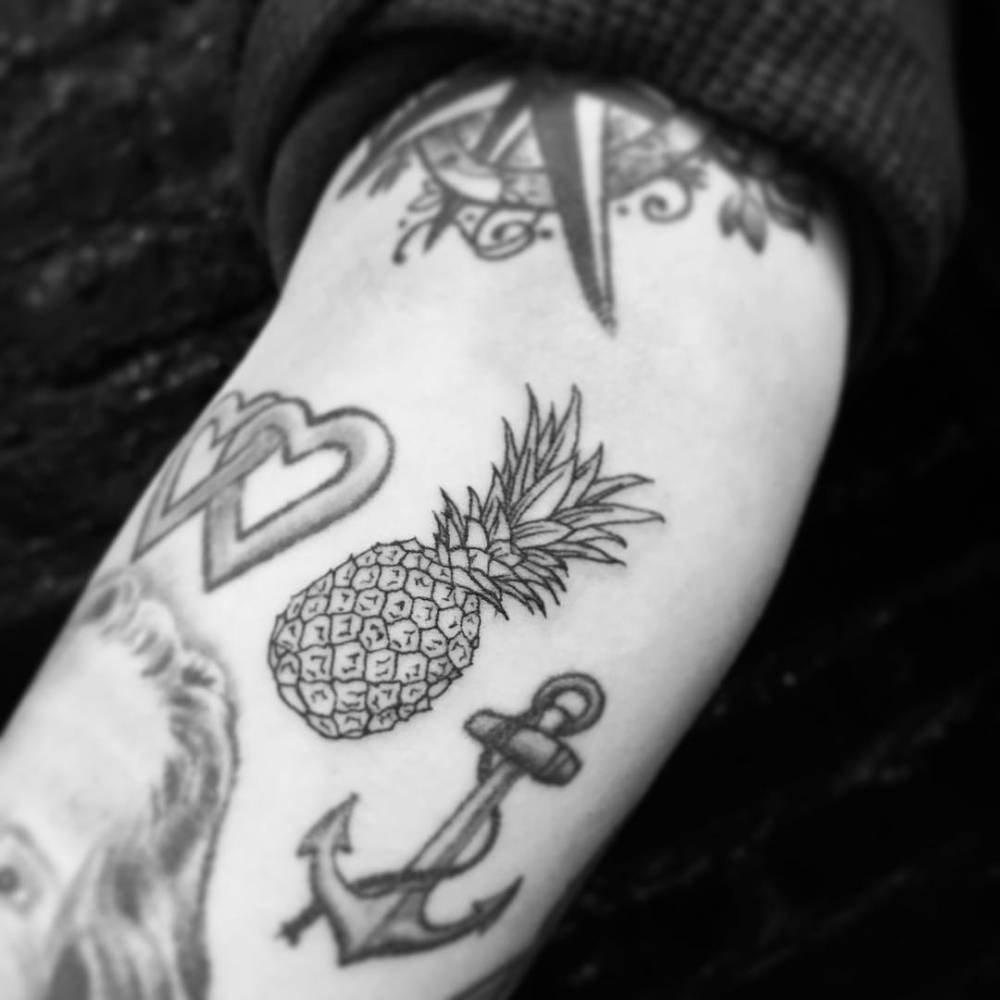 Pineapple tattoo located on the inner forearm.