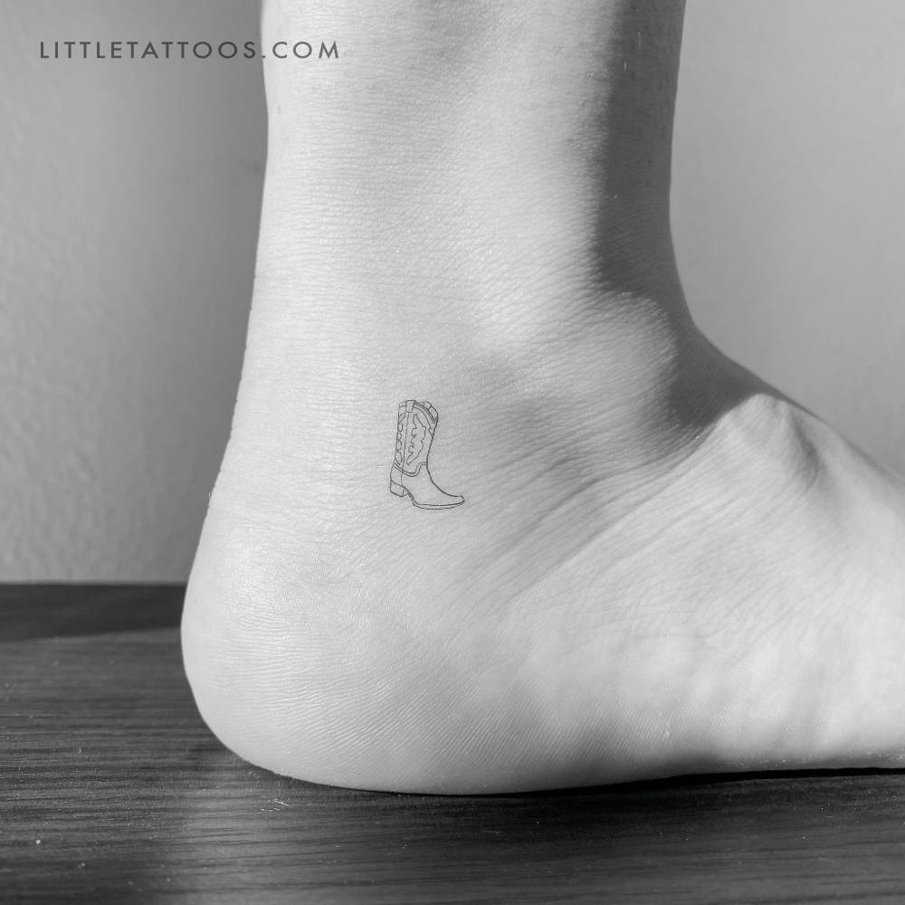 Tiny cowboy boot temporary tattoo in fine line style located on the ankle.
