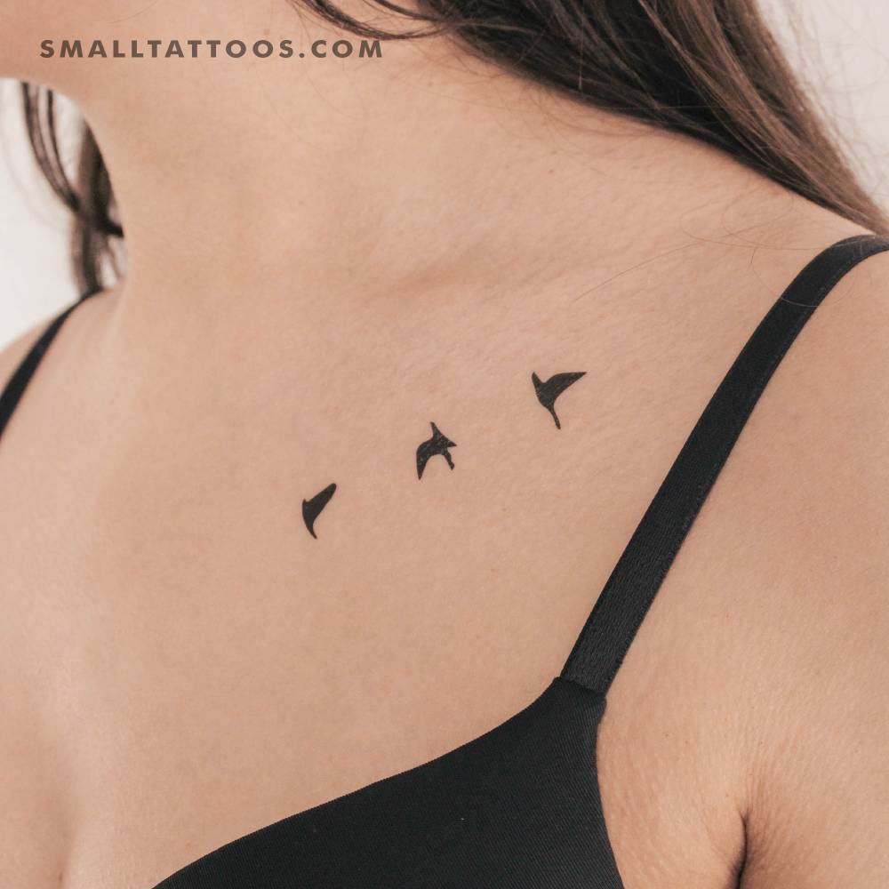 Minimalistic style flying birds temporary tattoo located on the collarbone.