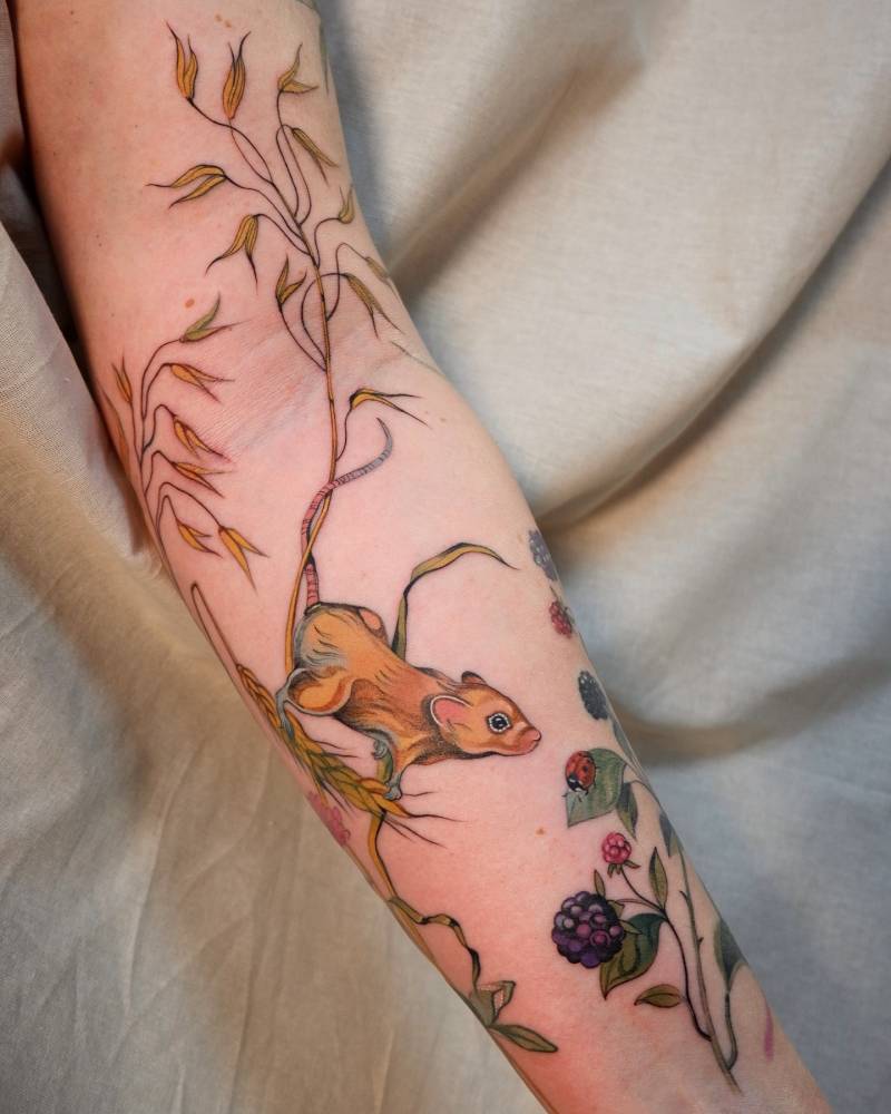 Neotraditional style mouse tattoo located on the inner forearm.