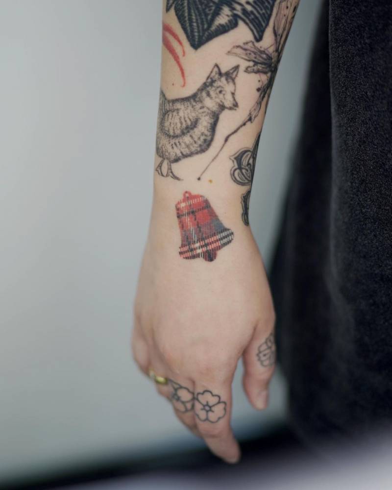 5 years healed, handpoked tartan bell tattoo located on the wrist.