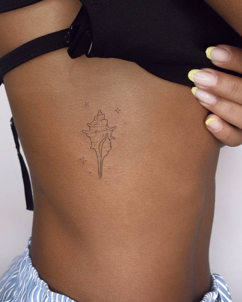 Tulip shell tattoo located on the rib, done in fine line style.