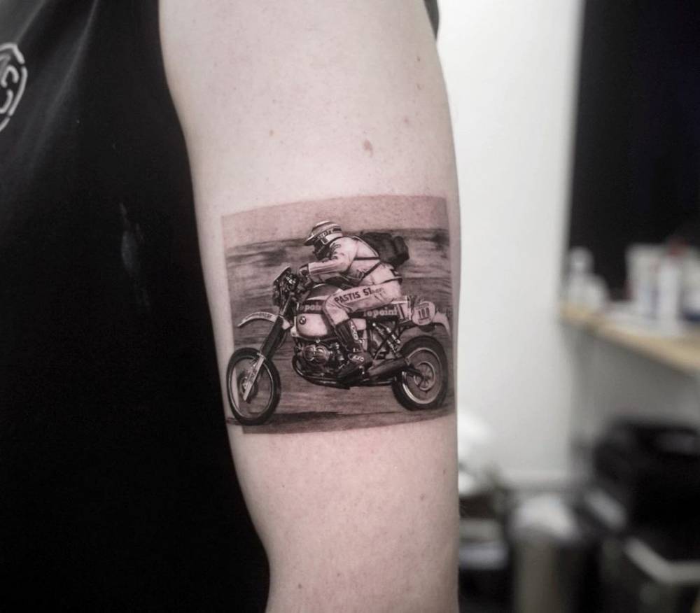 Hubert Auriol - legend of The Dakar Rally tattooed on the upper arm.