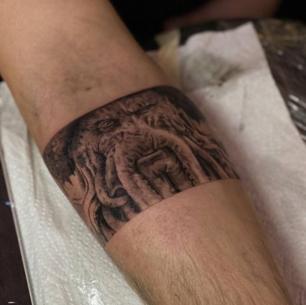 Micro-realistic Davy Jones portrait tattoo on the inner forearm.