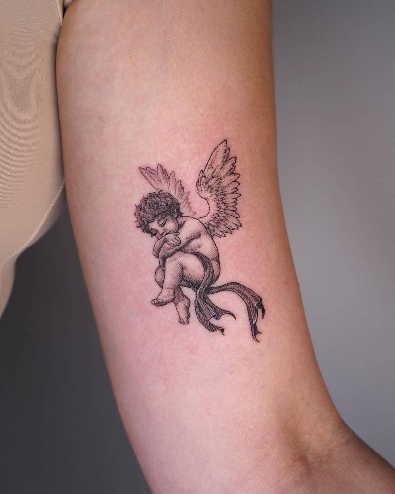 Cherub tattoo placed on the inner arm.