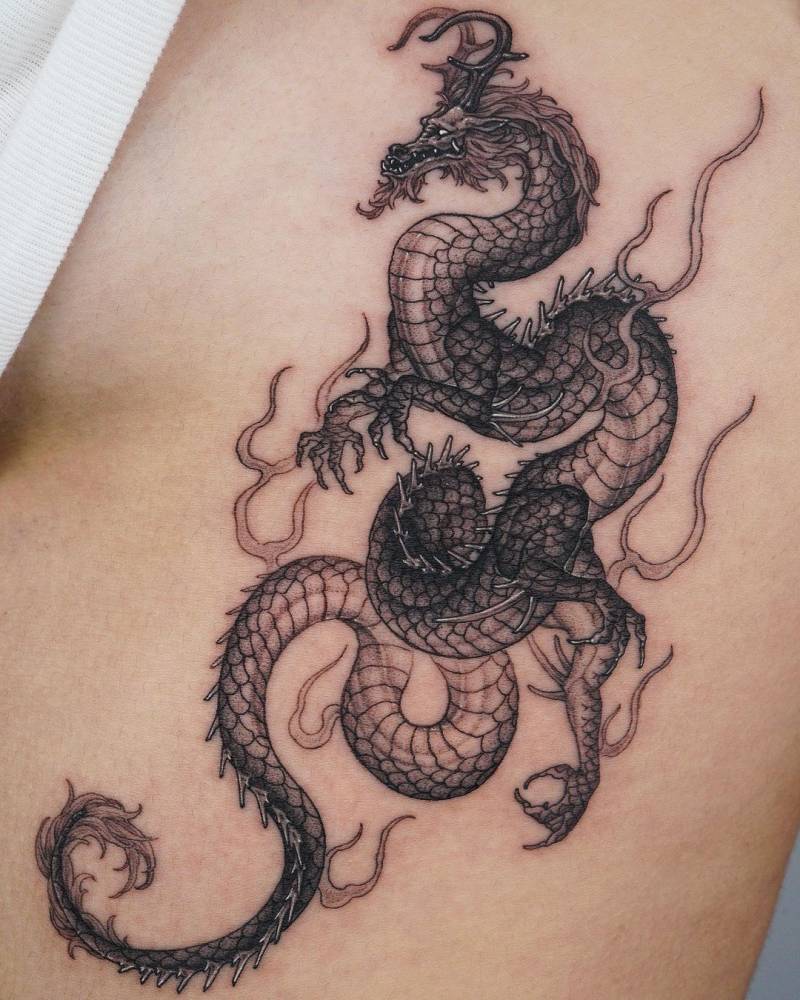 Dragon tattoo done on the rib, illustrative style.
