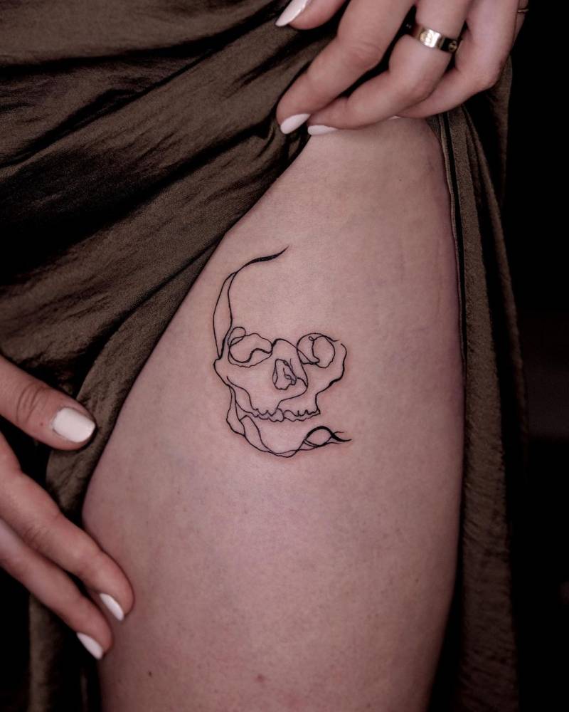 Abstract skull tattoo located on the pelvis.
