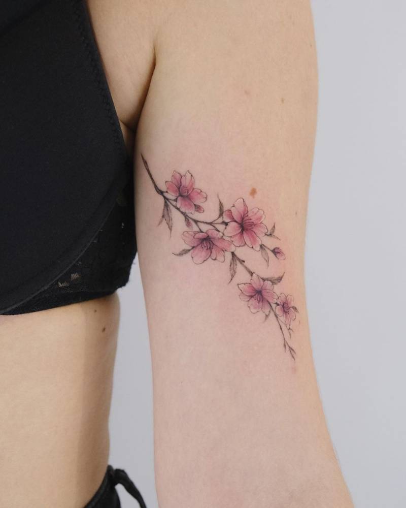 Cherry blossom tattoo located on the inner arm.