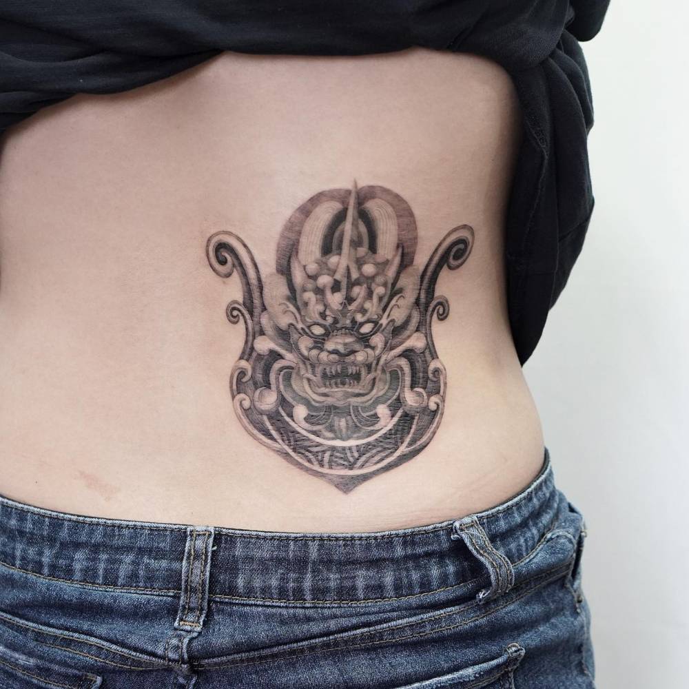 Haetae tattoo located on the lower back.