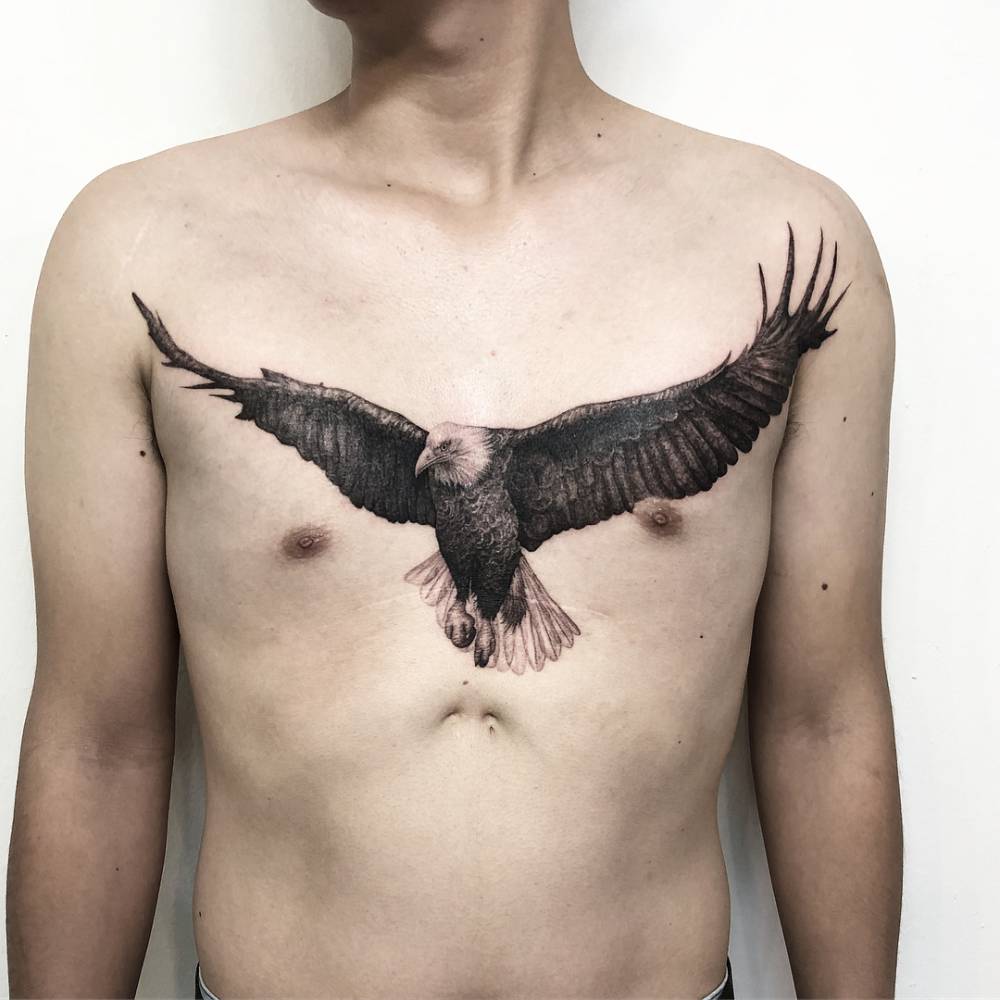 Eagle scar cover up tattoo located on the chest.