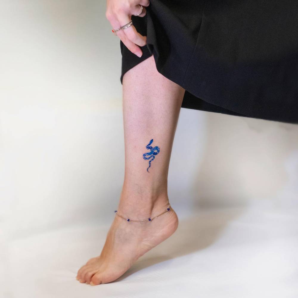 Porcelain snake tattoo located on the ankle.