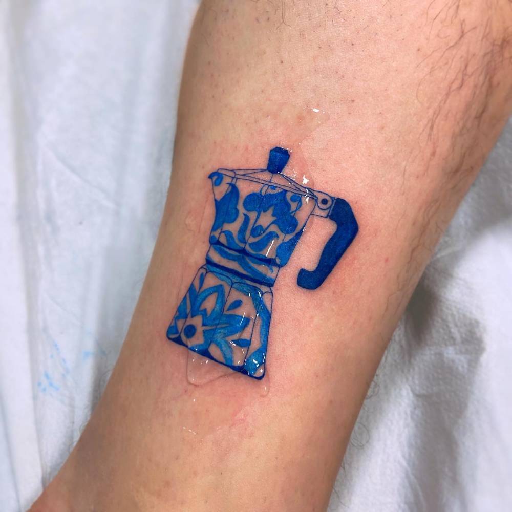 Contemporary style moka pot tattoo located on the ankle.