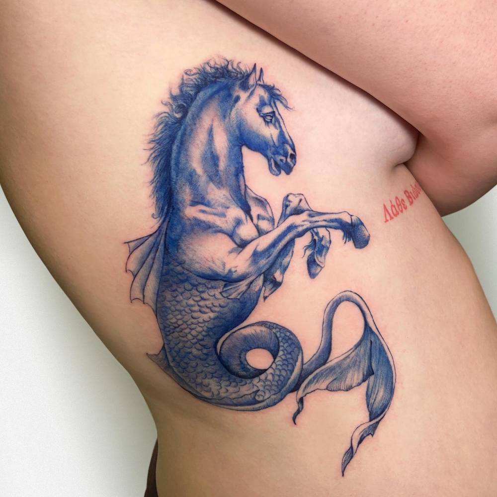 Blue hippocampus tattoo located on the rib, illustrative style.