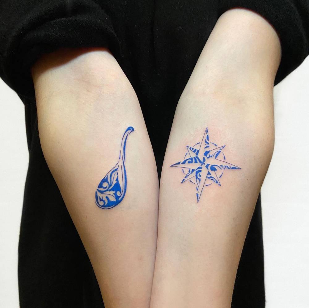 Porcelain chinese soup spoon and compass rose tattoos.