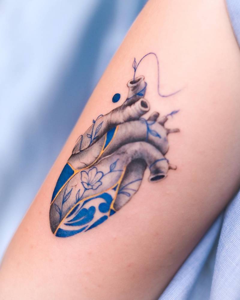 Kintsugi o porcelain heart tattoo located on the tricep.