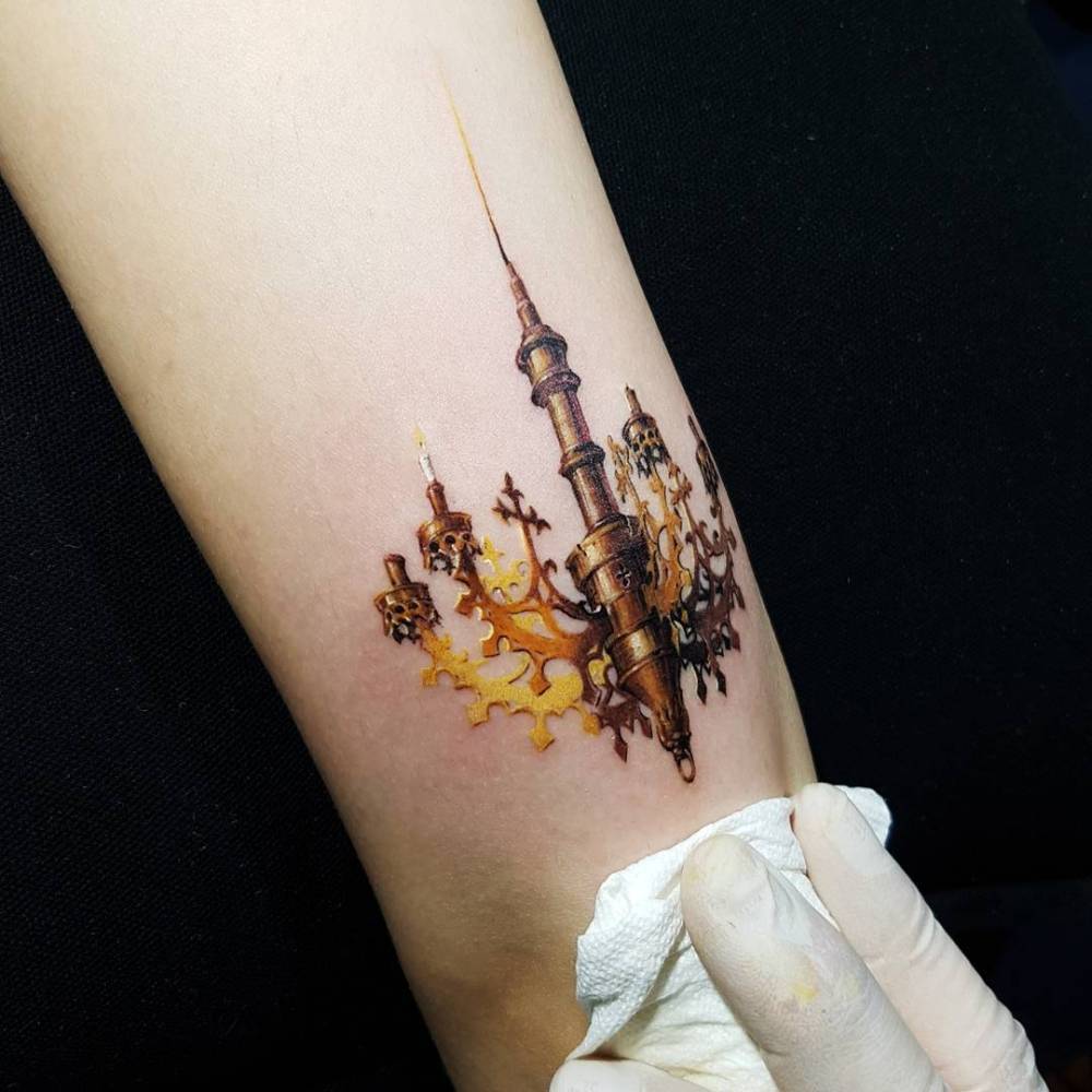 Micro-realistic style chandelier tattooed on the tricep.