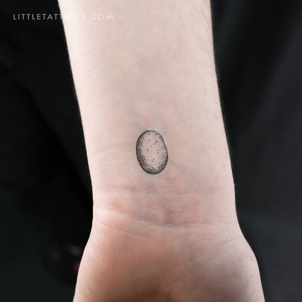 Tiny potato temporary tattoo in engraving style located on the wrist.