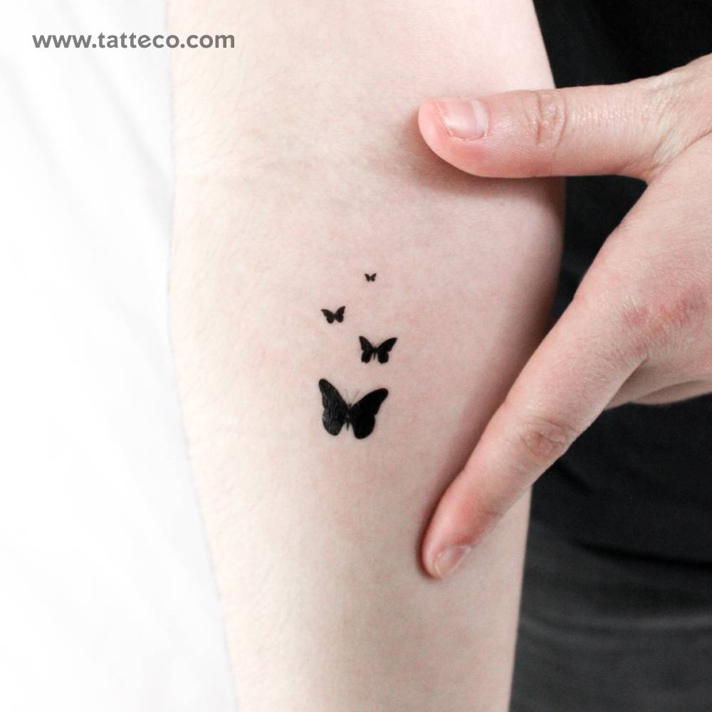 Butterfly family temporary tattoo located on the inner forearm.