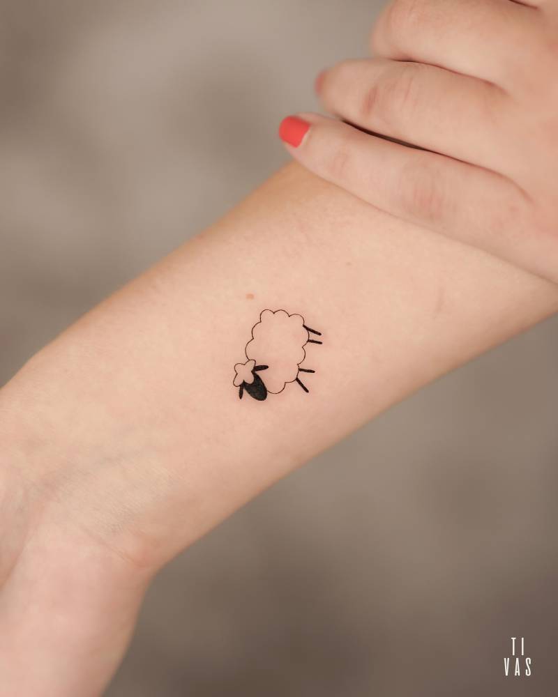Cute minimalistic sheep tattoo located on the wrist.