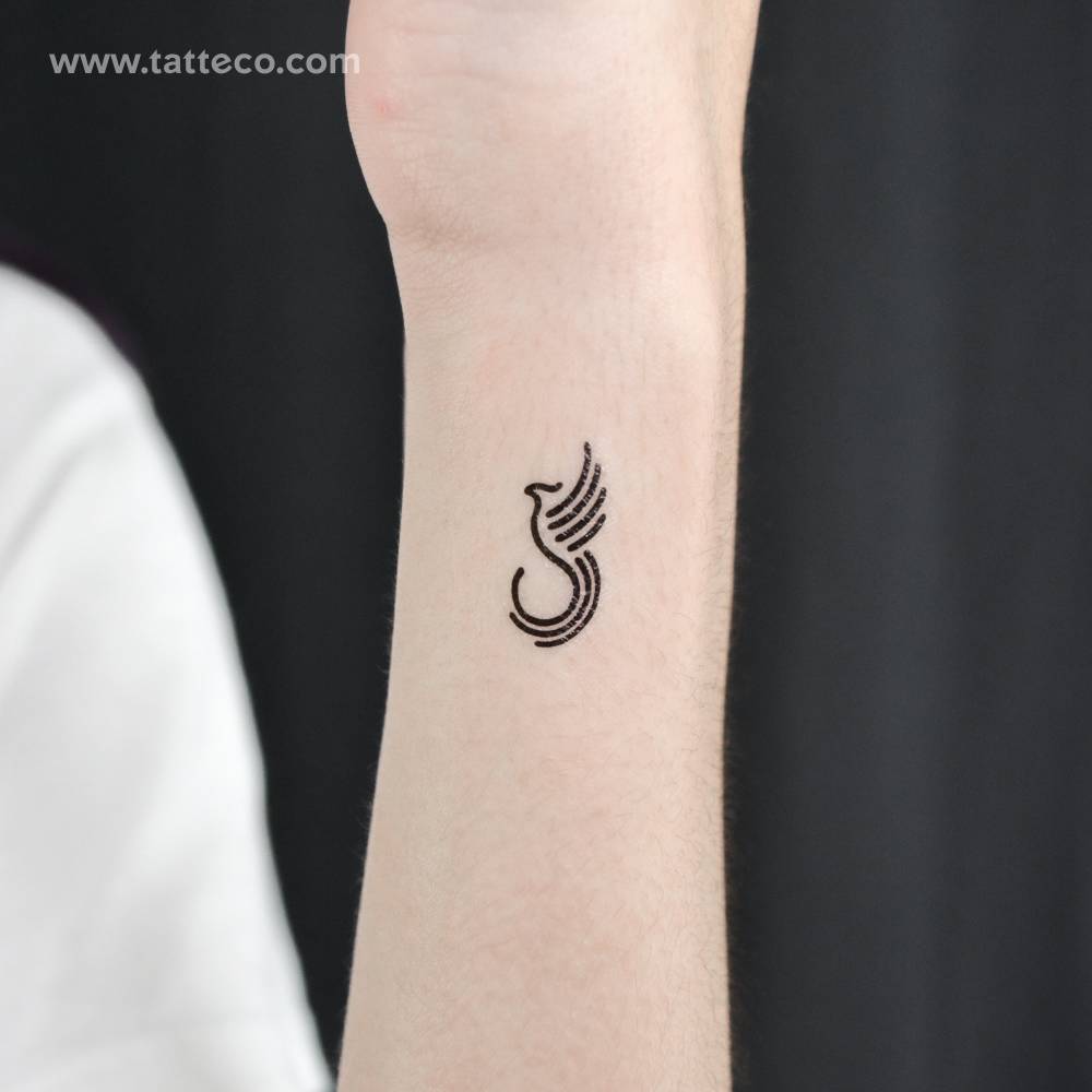 Minimalist phoenix temporary tattoo located on the wrist.
