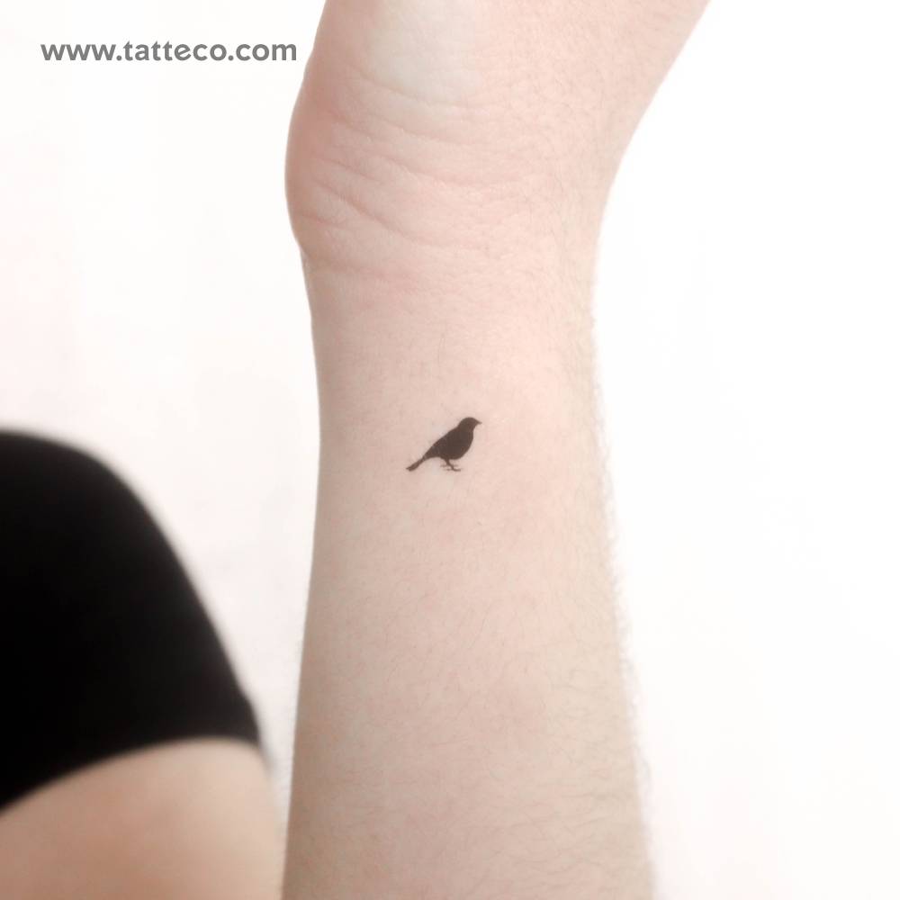 Tiny standing bird temporary tattoo located on the wrist.
