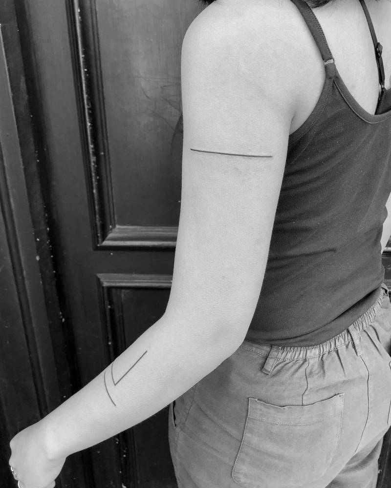 Freehand line composition tattoo located on the arm.