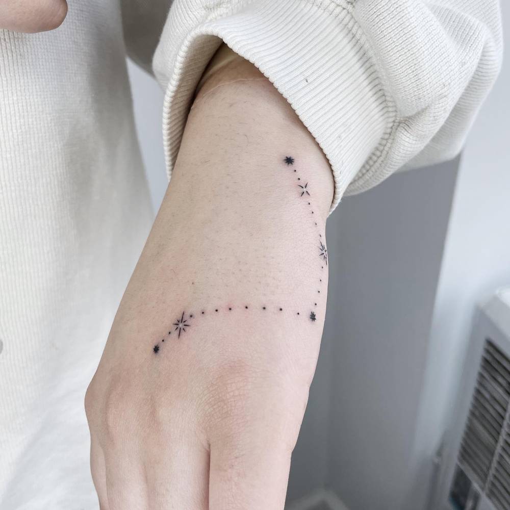 Asterism tattoo located on the hand.